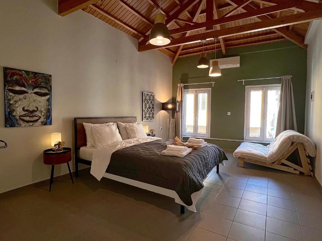 a bedroom with a bed and a chair in it at Iriki Loft, ένας ατμοσφαιρικός ρετρό χώρος στην Μυτιλήνη in Mytilene