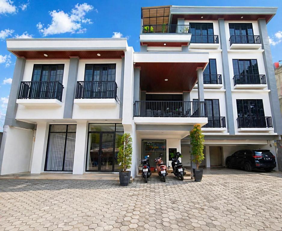 two motorcycles parked in front of a building at Twins Hotel Boutique Syariah in Bandung