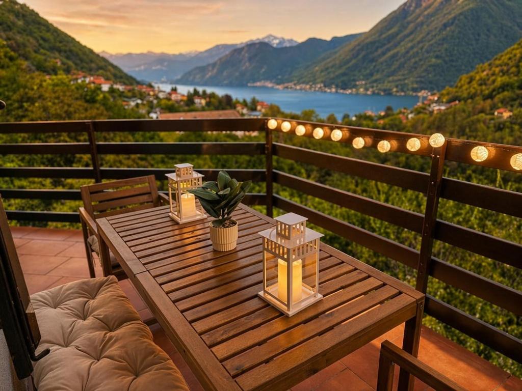 a wooden table on a balcony with a view of a lake at The Terrace Overlooking Lake Como in Muronico