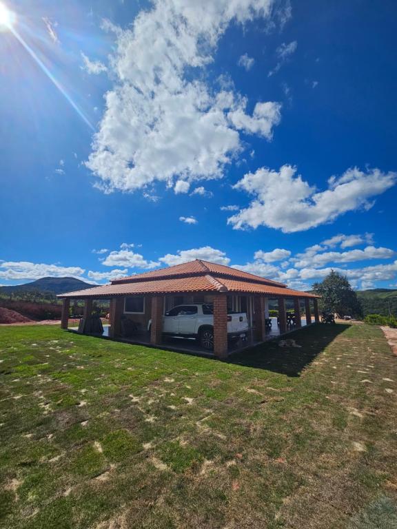 a house with a car parked in front of it at Solar do Ouro in São Thomé das Letras