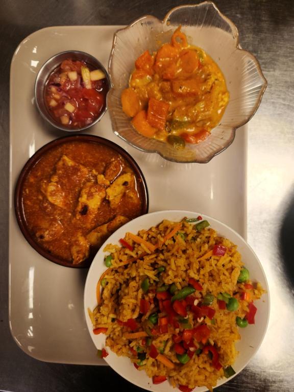 a white tray with different types of food on it at Gate 1 apartment in Måløy