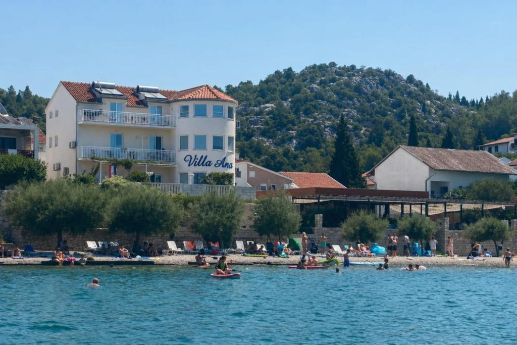 a group of people in the water at a beach at Villa Ante Apartments in Blace