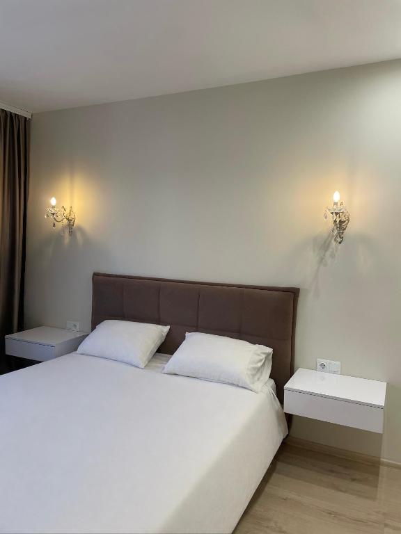 a bedroom with a large bed with two white pillows at Vivat in Berehove