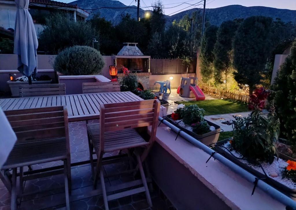 a patio with a table and chairs in a backyard at Casa Marianna-Luxury Riviera Retreat in Anavyssos