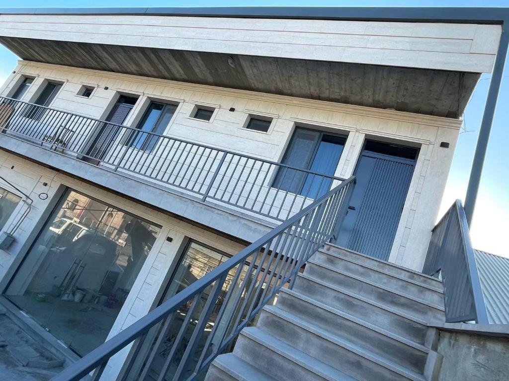 a house with stairs leading up to the front door at MM House in Yerevan