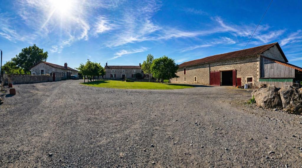 an empty road in front of a barn at Domaine de Beau Site in Peyrat-de-Bellac
