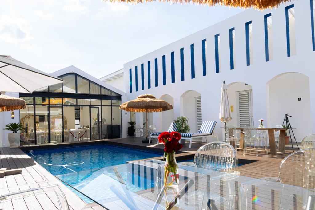 a villa with a swimming pool and a house at 18 On OniX - World Class in Four Ways