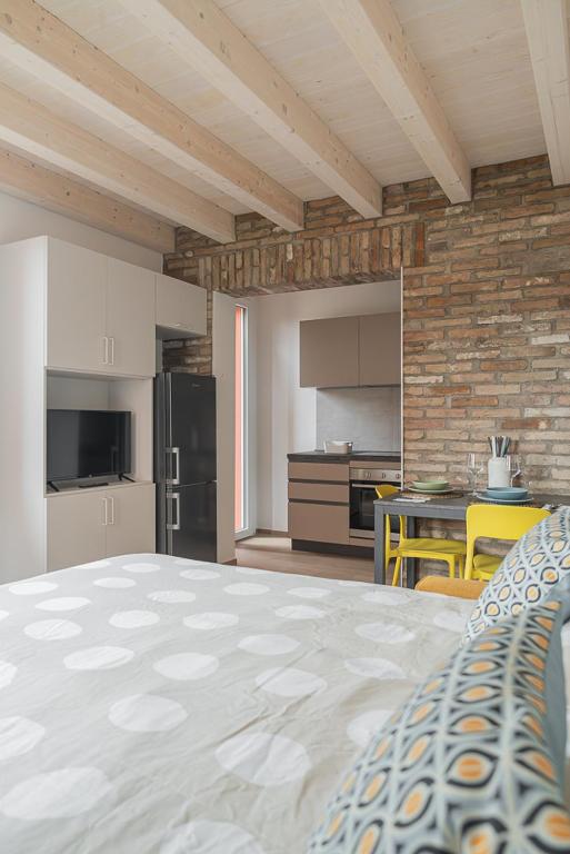 a kitchen with a large bed in a room at LaNica Maison in Castelfranco Emilia