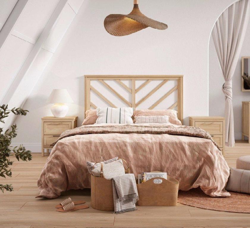 a bedroom with a large bed with a wooden headboard at TutiFuti Casa in Chuy