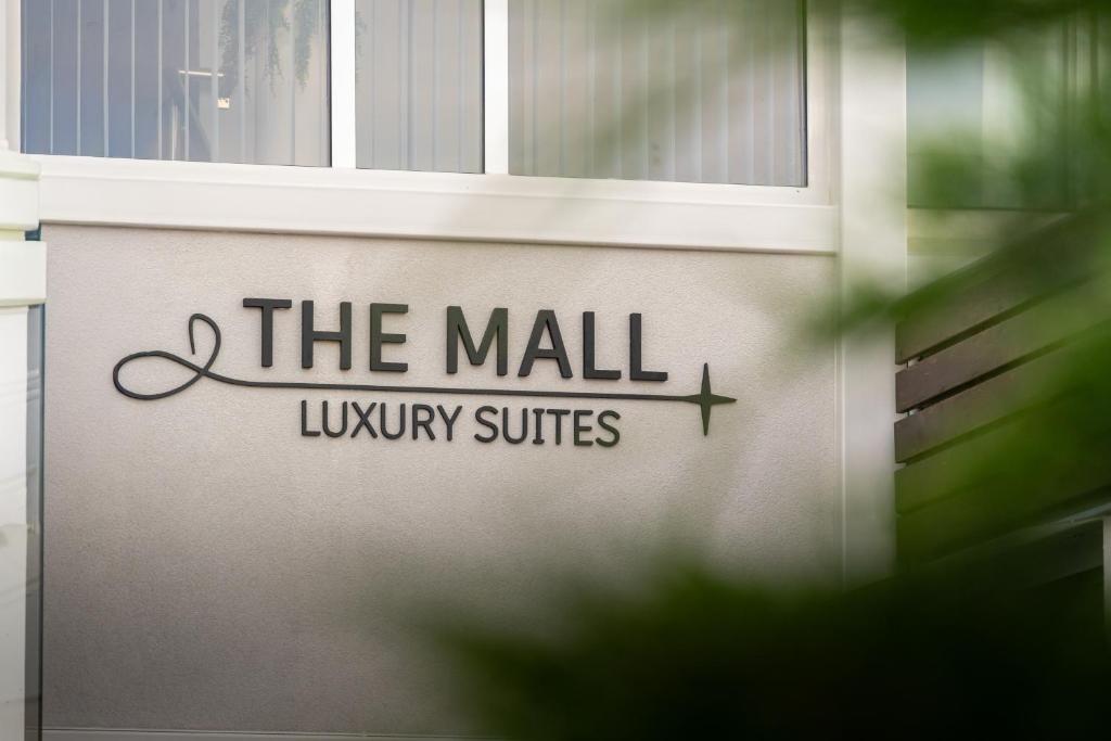 a sign on the wall of a library at The Mall Luxury Suites in Nikiti