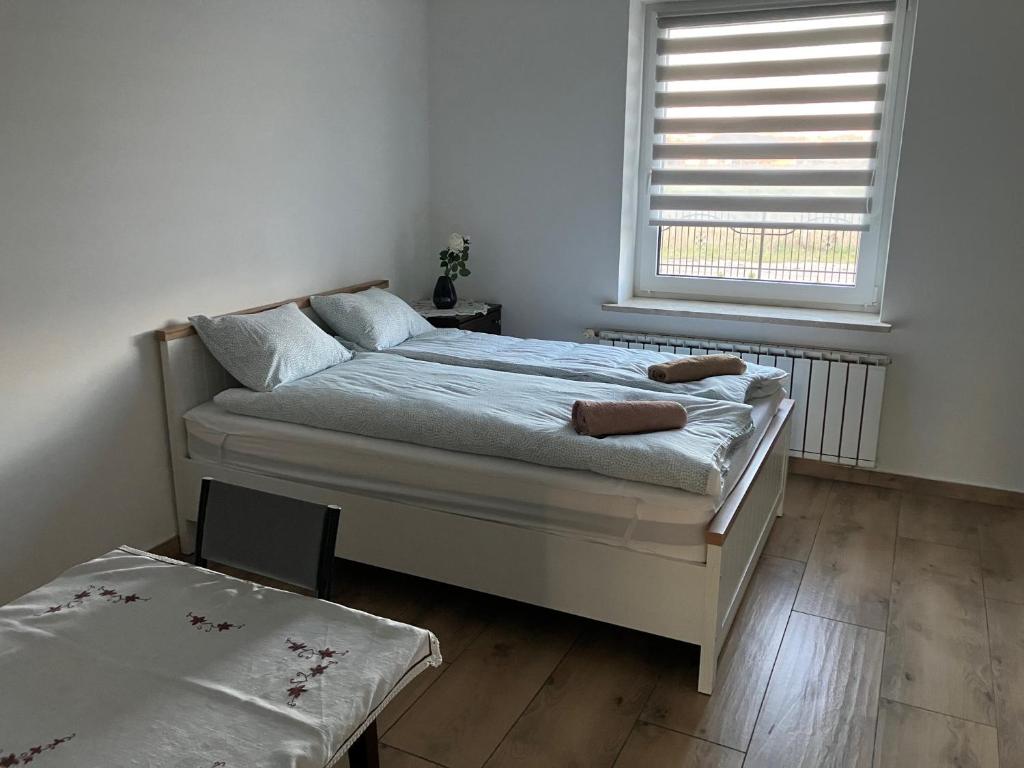 a bedroom with a bed and a window in it at Don Kichot in Grajewo