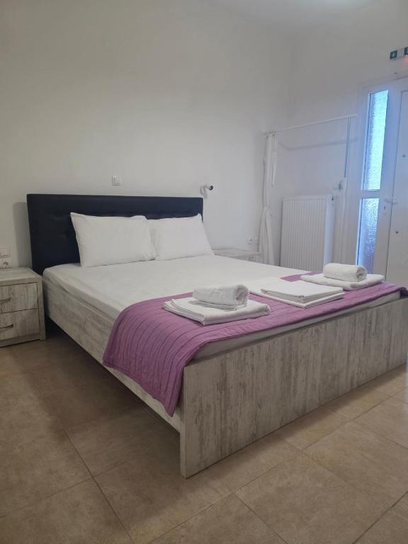 a large bed with two towels on top of it at Anemoni apartment Asprovalta in Asprovalta