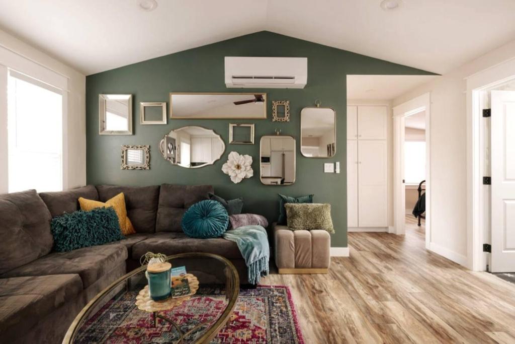 a living room with a brown couch and a green wall at Charming Home Downtown Paso Robles in Paso Robles