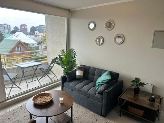 a living room with a couch and a table at LUGAnO 301 in Temuco