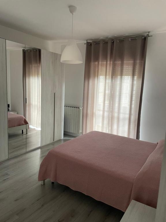 a bedroom with a bed and a large mirror at Domus de Silvi in Silvi Marina