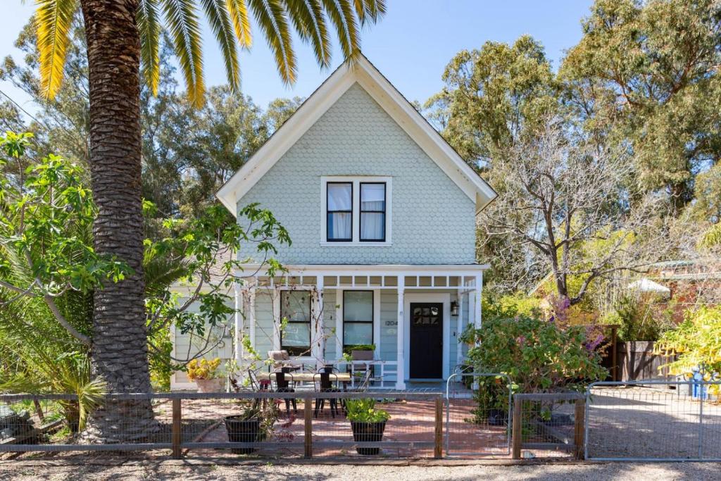 a house with a palm tree in front of it at Iconic Modern Farmhouse in San Luis Obispo