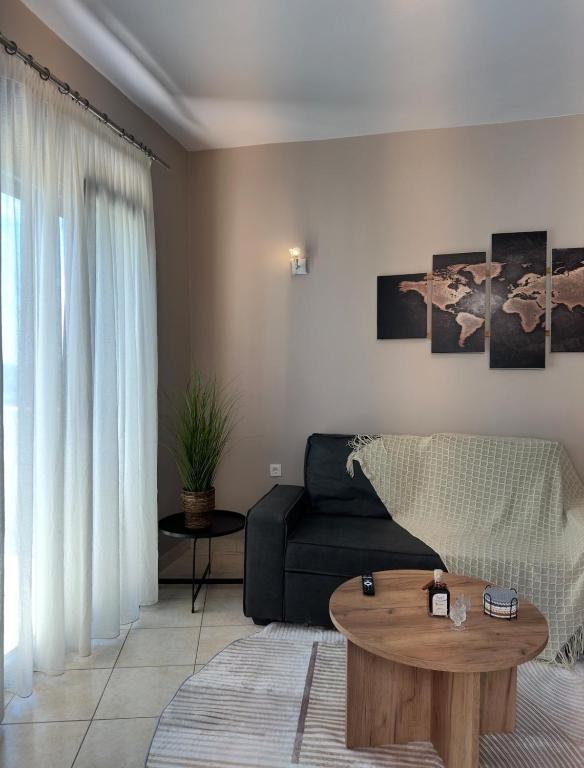 a living room with a couch and a coffee table at Kaloula's home in Keramoto