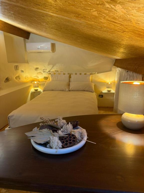 a bedroom with a bed and a table with a plate on it at Casa Dani - terrazza relax, parcheggio gratuito e comfort a due passi da Oneglia in Imperia