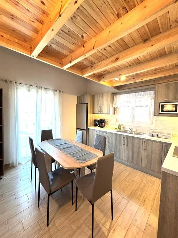 a kitchen with a table and chairs in a room at Theo Two-Bedroom Apartment in Marathias