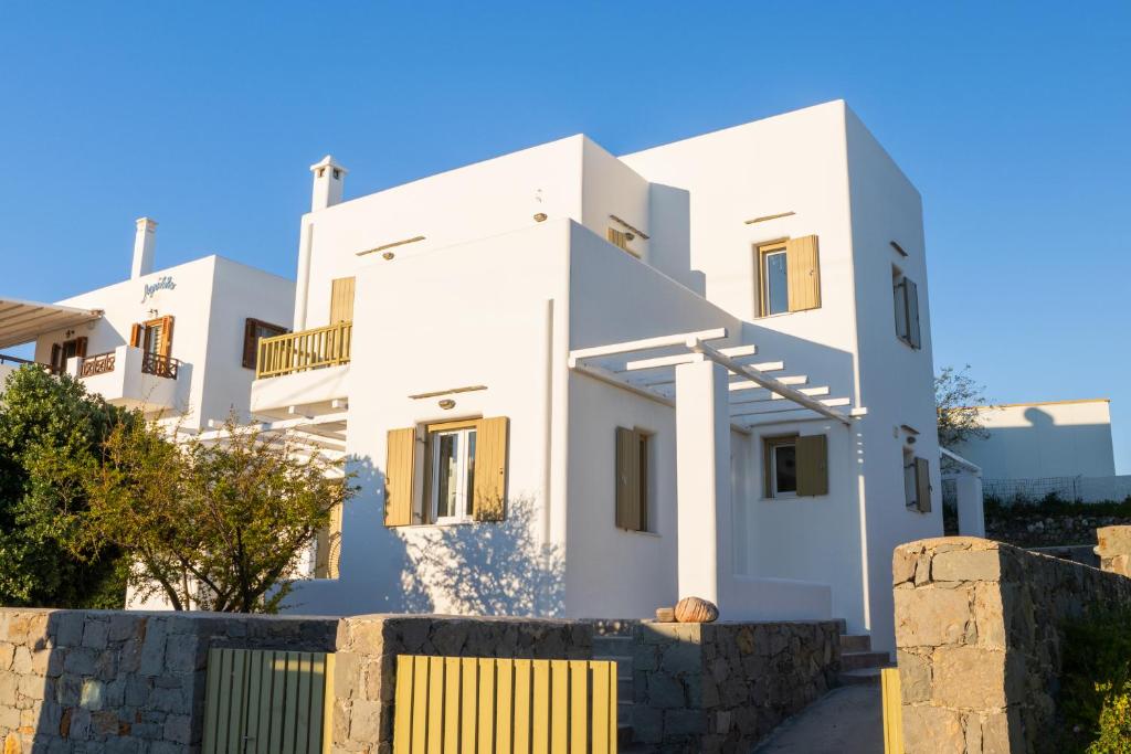 a white house with a fence in front of it at Summer Villa in Adamantas