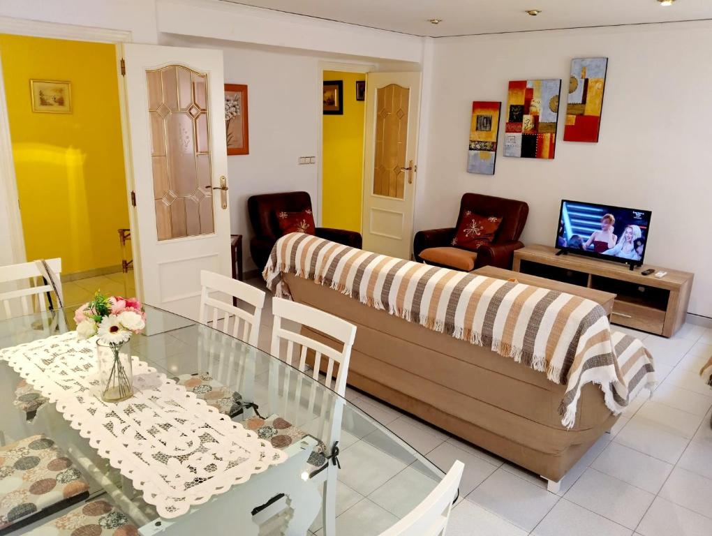 a living room with a couch and a glass table at La Rose in Gandía