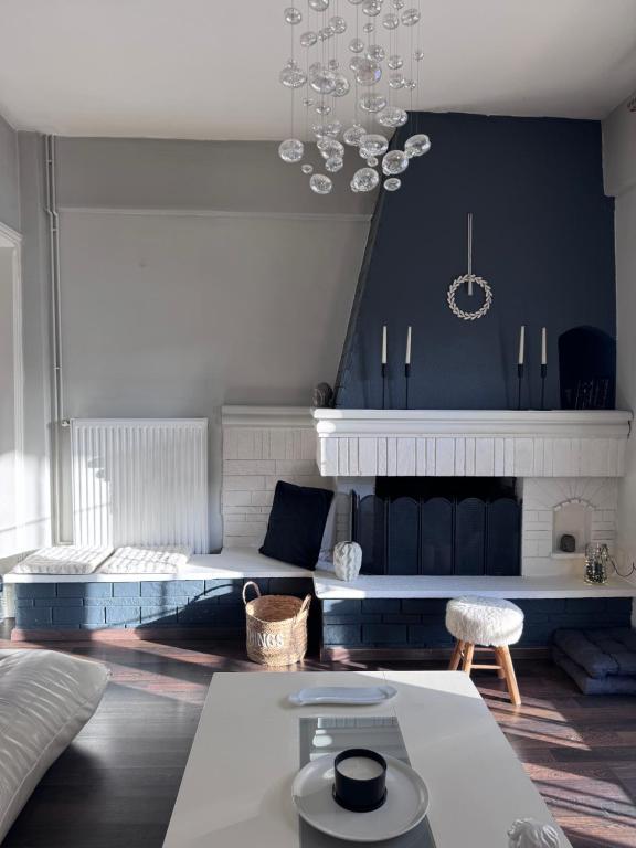 a living room with a couch and a chandelier at SugarV Home in Kilkis