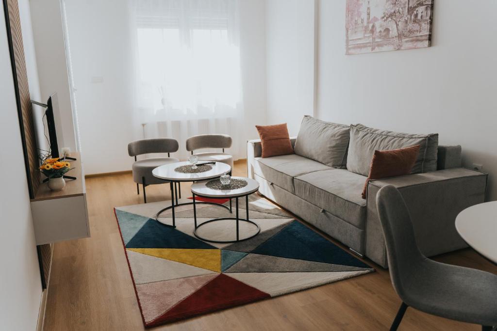 a living room with a couch and two tables at Stan Brana in Ruma
