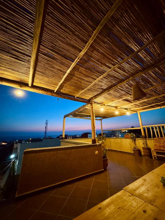 awning on top of a building with a view at Surf & bask HOME in Tamraght Ouzdar