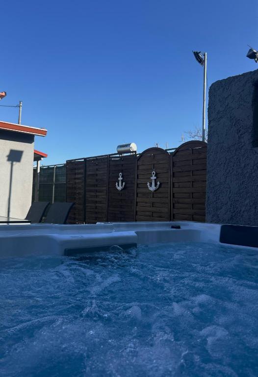 a swimming pool with water in front of a fence at MtsHome I Luxury Stay with Jacuzzi in Áyios Spirídhon