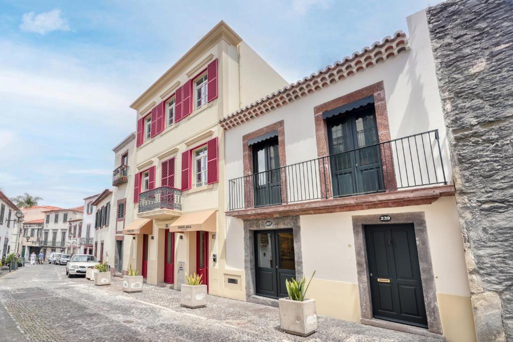 a row of houses on a street at Chapelaria Boutique Hotel in Funchal