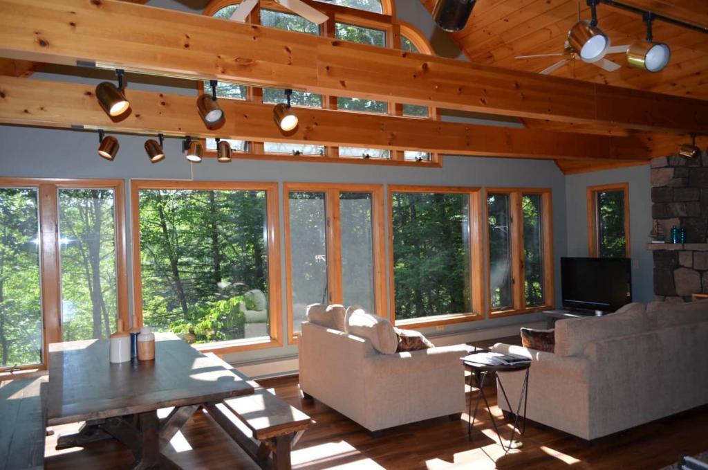 a living room with a lot of windows at Shimmering Cove Retreat in Naples