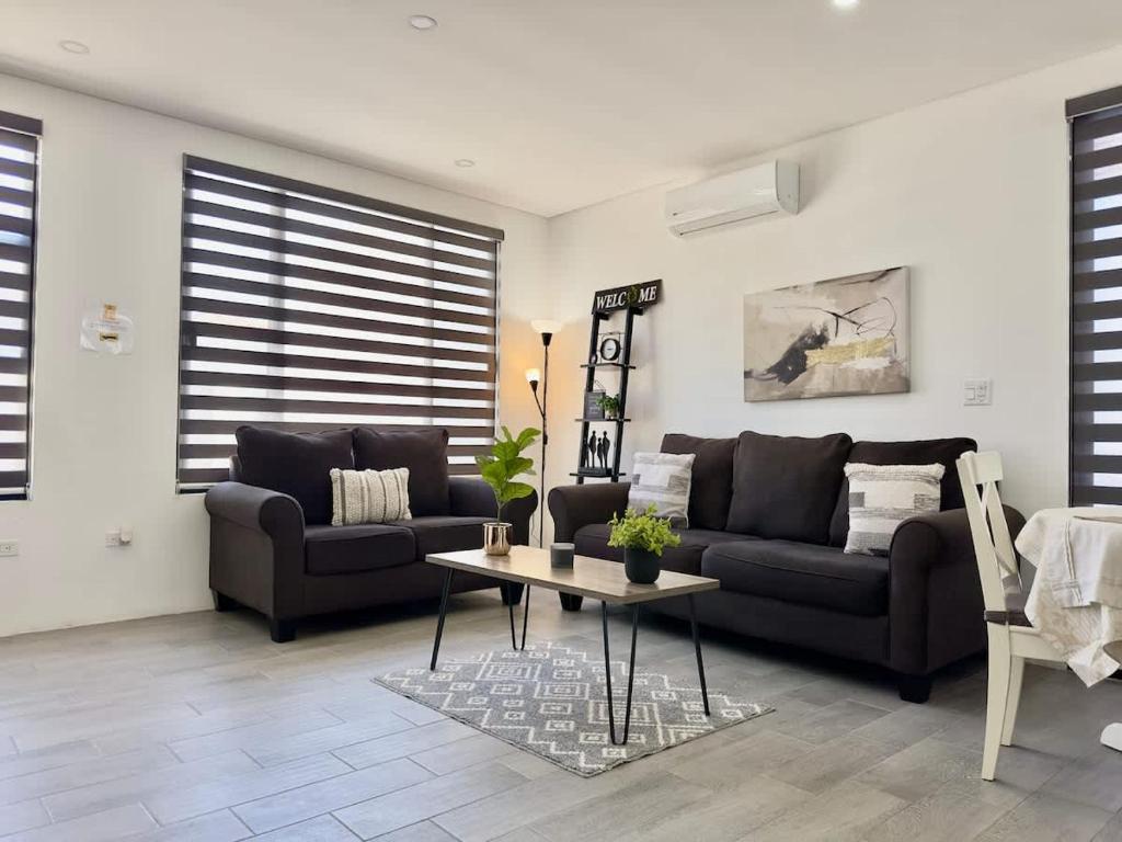 a living room with two couches and a coffee table at House Ayala 2BR 2Bd in Rosarito