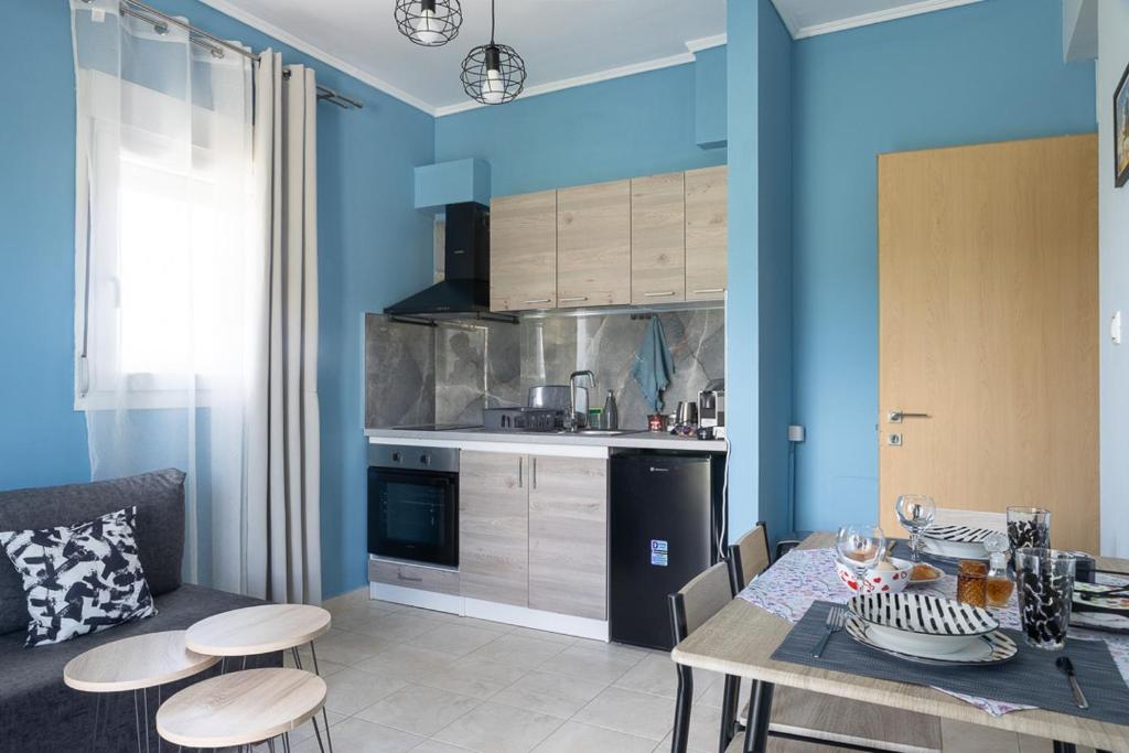 a kitchen and dining room with a table and chairs at Lanari Valley House 2 in Thermi