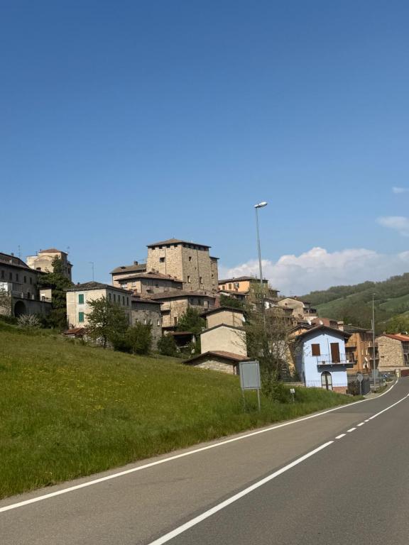 an empty road next to a city with buildings at La casa dei Nonni in Romagnese