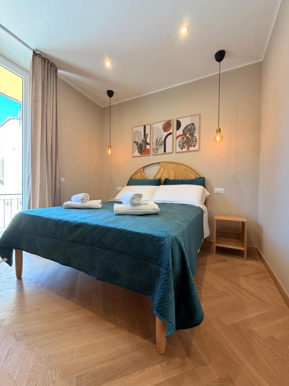 a bedroom with a bed with two towels on it at Velvet Rooms Florence in Florence