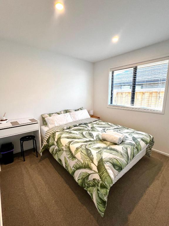 a bedroom with a bed and a desk and a window at Room and Private Bathroom in Woodend in Woodend
