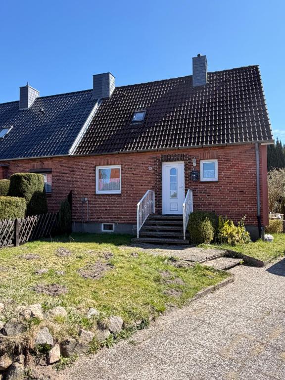 a red brick house with a white door at Room in Rendsburg in Rendsburg