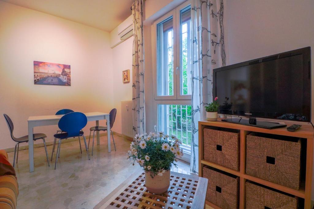 a living room with a large television and a table at B&B Casalecchio Appartamento privato in Casalecchio di Reno