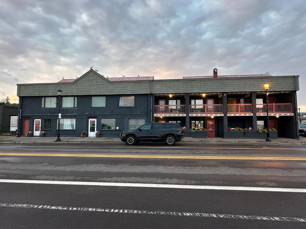 a black car parked in front of a building at The Harbor Inn in Grand Marais