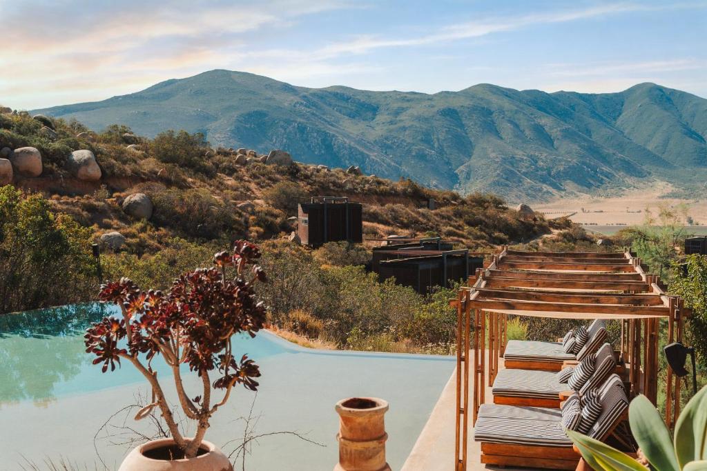 a swimming pool with a view of a mountain at Encuentro Guadalupe in Valle de Guadalupe