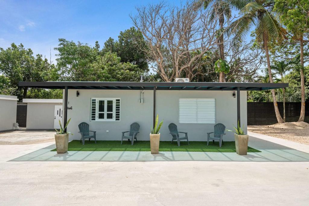 a small house with a black roof at Balandras Beach Stay 1 Beach & Pool Access in Dorado