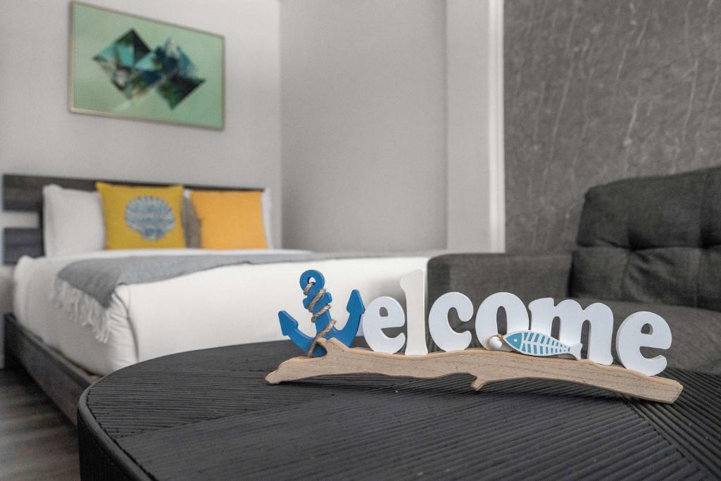 a table with a welcome sign on top of a room at Balandras Beach Stay 3 Beach & Pool Access in Dorado