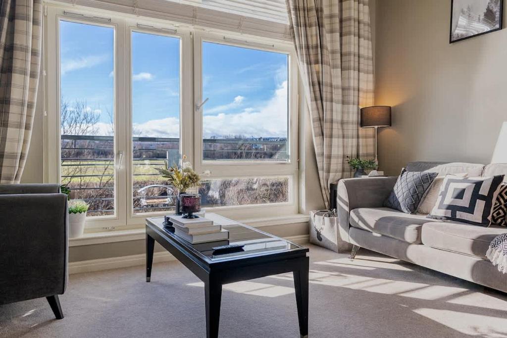 a living room with a couch and a table and a window at Stirling Riverview Apartment - Free Parking in Stirling