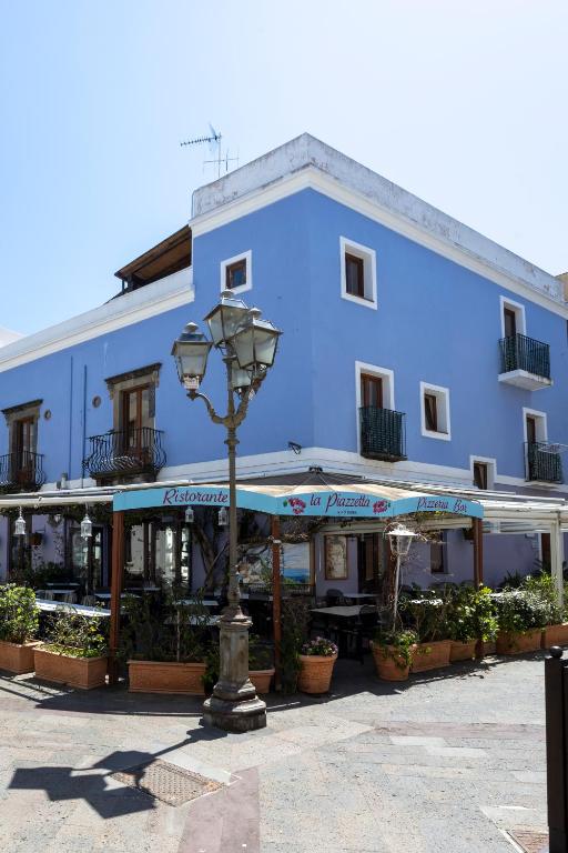 a blue building with a street light in front of it at Case Vacanze Albamarina in Lipari
