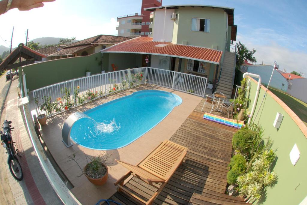 een zwembad op een terras naast een huis bij Pousada Mar de Almirante in Penha