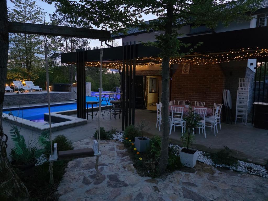 a patio with a table and chairs next to a pool at Villa Kristal Slatina- Private Pool & Jacuzzi BBQ in Slatina Varoš