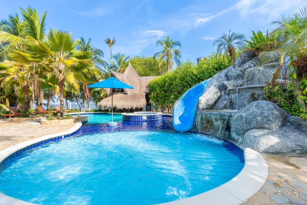 a pool with a water slide in a resort at Cabañas Aqua Blue Coveñas in Coveñas