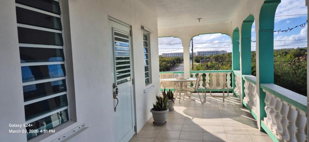 a balcony of a house with a table and chairs at Gumbsie Villas in The Valley