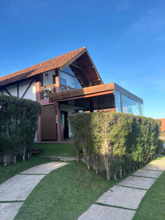 a house with a walkway in front of it at Chalé Suiço Bananeiras in Bananeiras