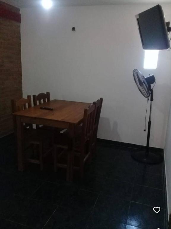 a room with a table with chairs and a fan at Departamento Cura Brochero in Villa Cura Brochero